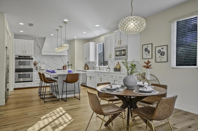 dining room featuring visible vents, recessed lighting, and light wood-type flooring