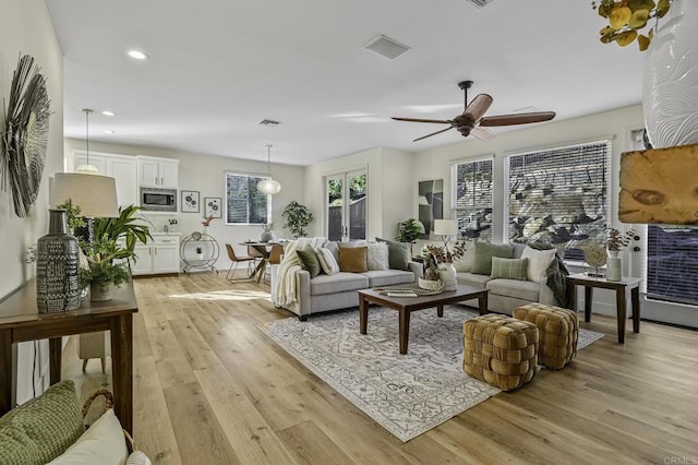 living room with visible vents, recessed lighting, light wood-type flooring, and ceiling fan