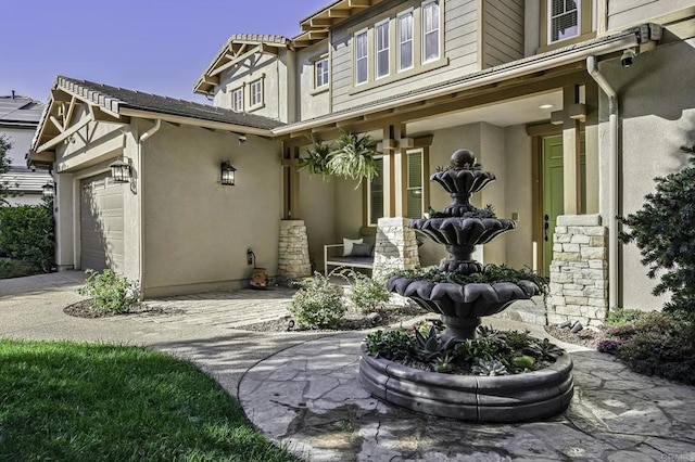 exterior space featuring a garage and stucco siding