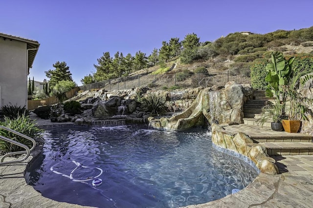 view of pool featuring fence