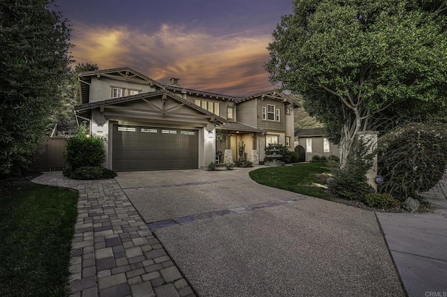 view of front facade featuring a garage, driveway, and stucco siding