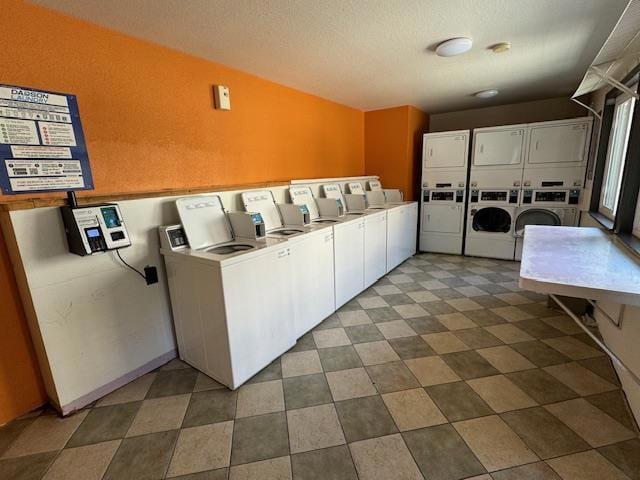 laundry area featuring a textured ceiling, stacked washer and clothes dryer, and independent washer and dryer