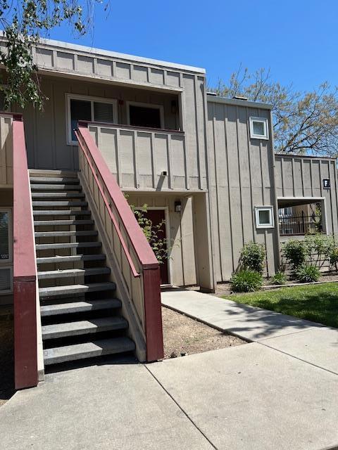 view of exterior entry with a balcony