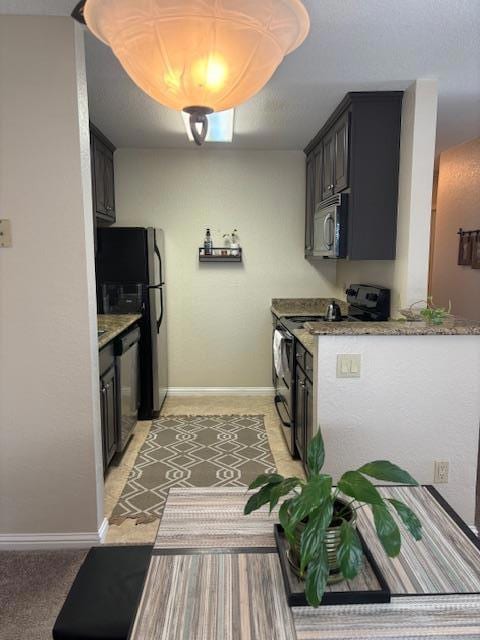 kitchen featuring light stone counters and stainless steel appliances