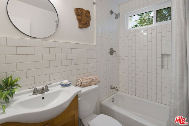 full bathroom featuring vanity, shower / bath combination with curtain, toilet, tile walls, and tasteful backsplash