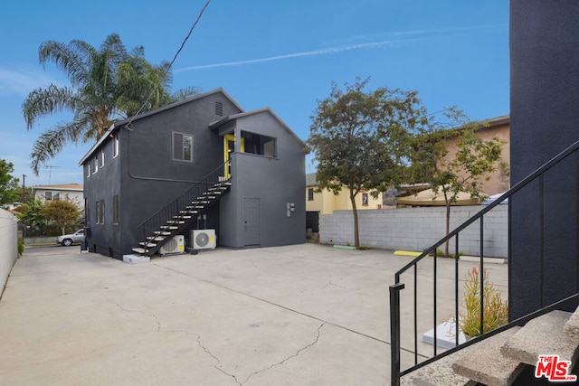 back of property featuring ac unit