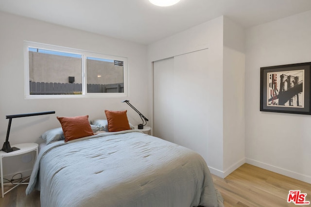 bedroom featuring light hardwood / wood-style floors and a closet