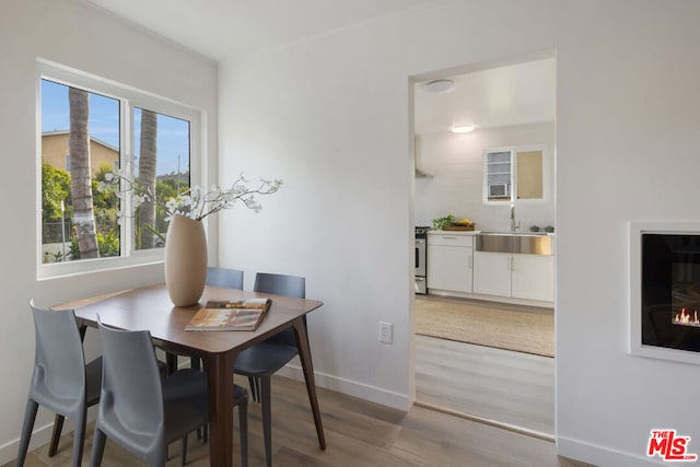 dining room featuring hardwood / wood-style floors and sink