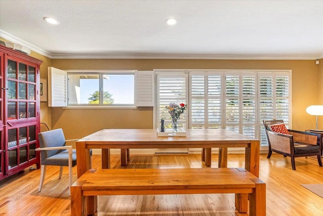 dining room featuring ornamental molding and light hardwood / wood-style floors