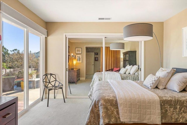 bedroom featuring light colored carpet and access to outside