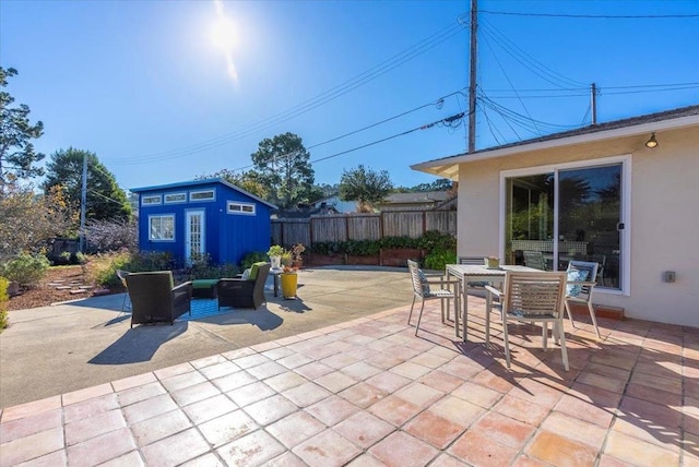 view of patio featuring an outbuilding