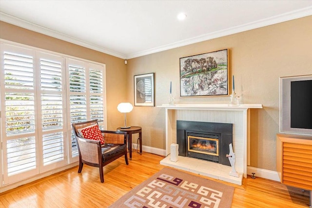 sitting room featuring wood-type flooring and crown molding