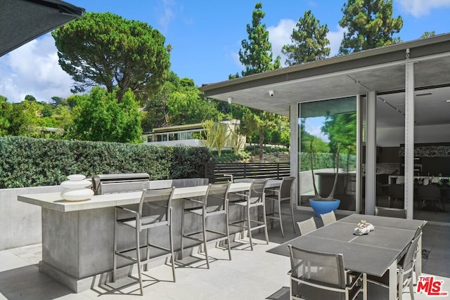 view of patio with an outdoor bar