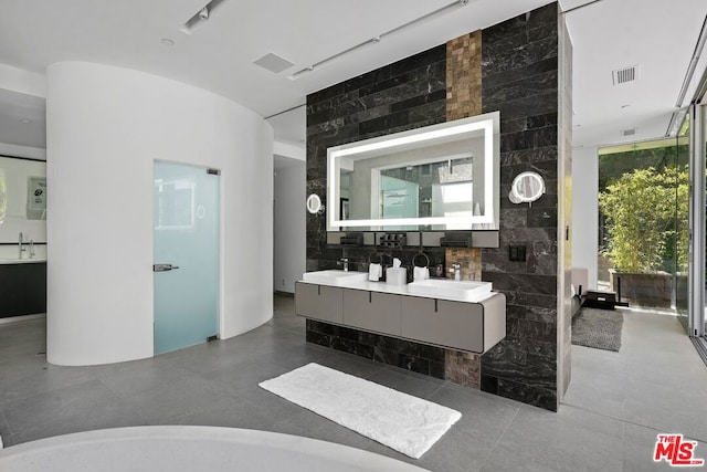 bathroom featuring vanity and a wall of windows