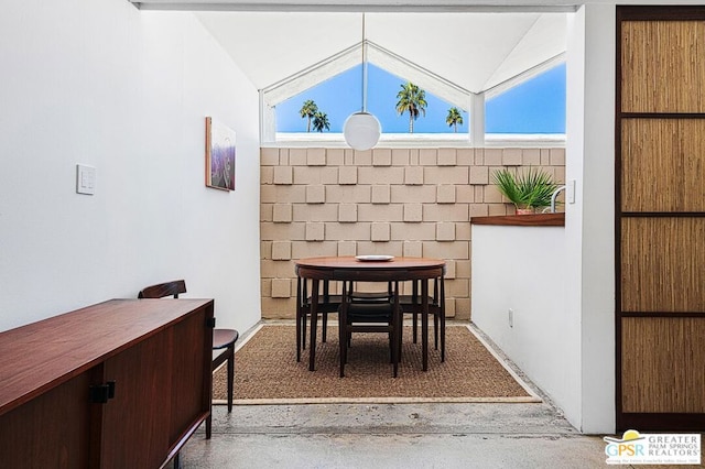 dining room featuring lofted ceiling