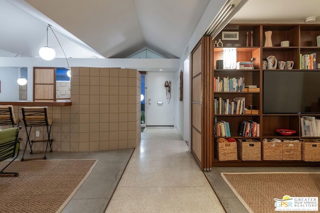 corridor featuring lofted ceiling