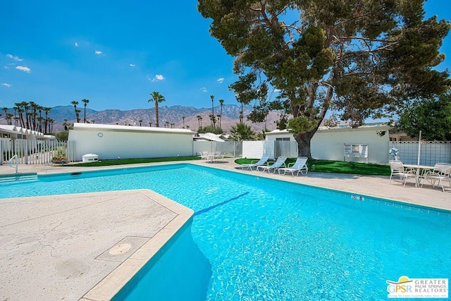 view of swimming pool featuring a mountain view and a patio