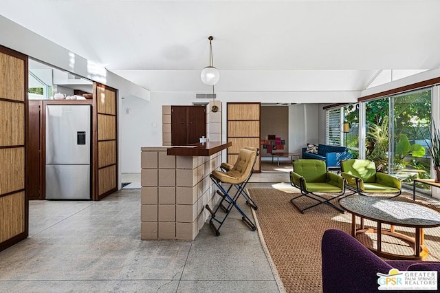 kitchen featuring a wealth of natural light and stainless steel fridge