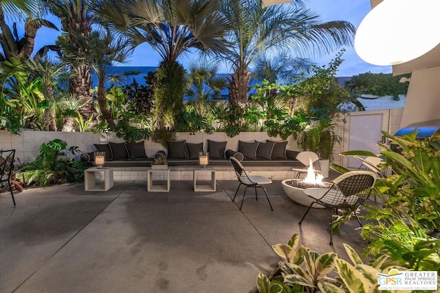 view of patio / terrace with an outdoor living space with a fire pit