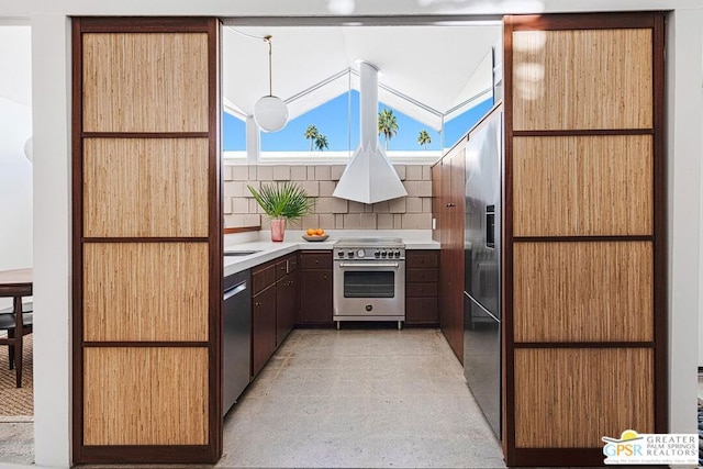 kitchen featuring tasteful backsplash, lofted ceiling, stainless steel appliances, and custom exhaust hood