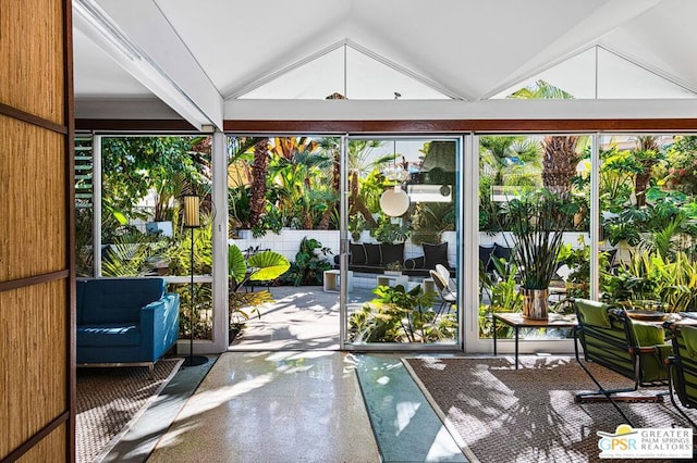 doorway with vaulted ceiling and plenty of natural light