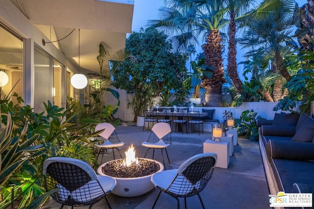 view of patio / terrace with an outdoor living space with a fire pit