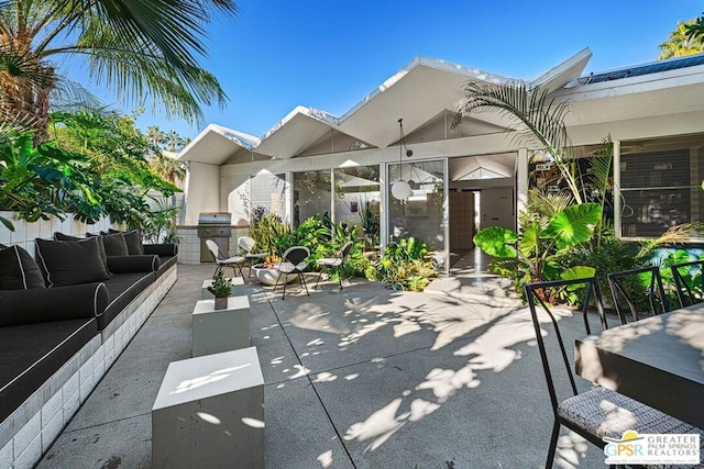 view of patio with an outdoor hangout area and grilling area