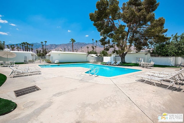 view of pool featuring a mountain view and a patio area