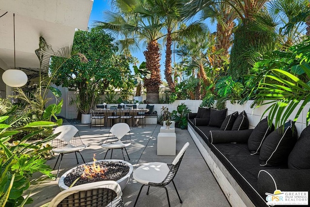 view of patio / terrace with an outdoor living space with a fire pit