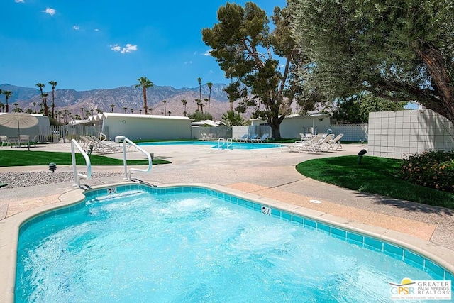 view of pool featuring a mountain view and a patio area