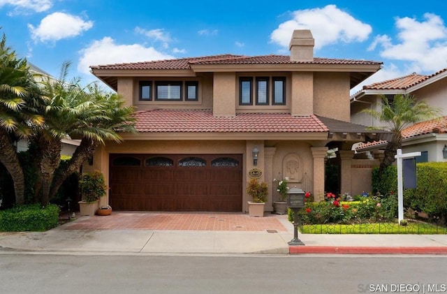 mediterranean / spanish home with a garage