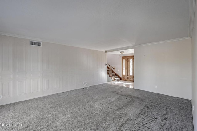 carpeted spare room featuring ornamental molding