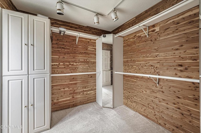 walk in closet featuring light colored carpet