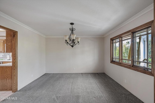 carpeted empty room with ornamental molding and an inviting chandelier