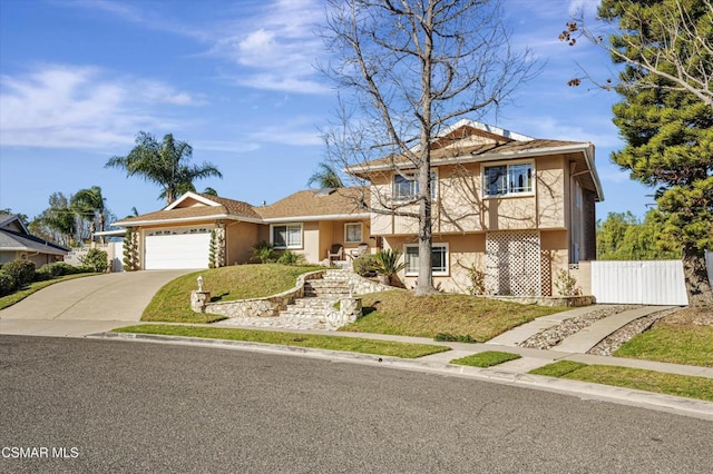 view of front of home with a front yard and a garage