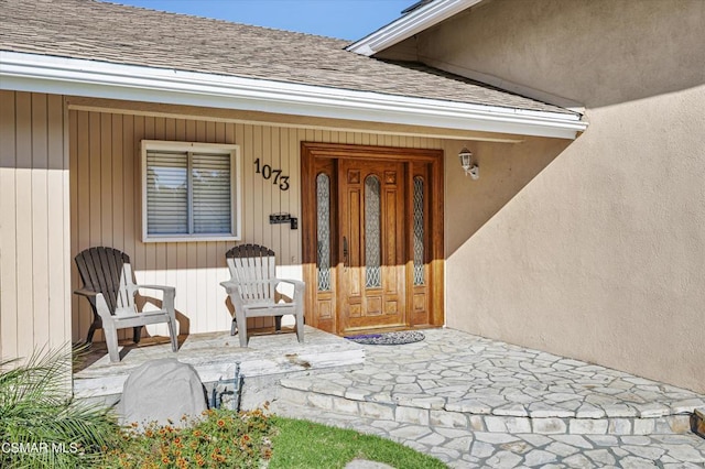 doorway to property featuring covered porch