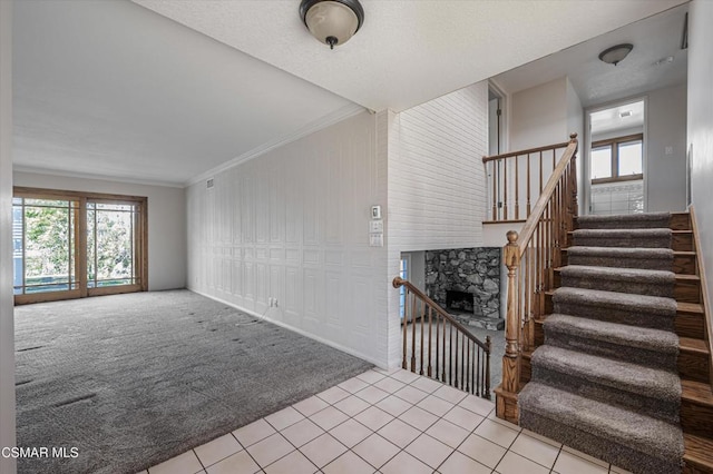 interior space with a fireplace, light colored carpet, and ornamental molding