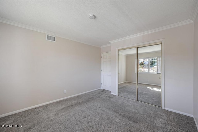 unfurnished bedroom with carpet flooring, a closet, and crown molding