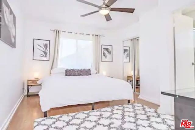 bedroom with light wood-type flooring and ceiling fan