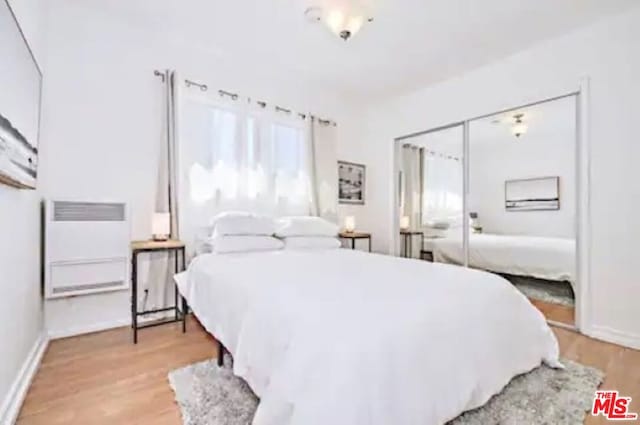 bedroom featuring light hardwood / wood-style flooring and a closet