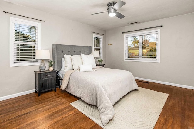 bedroom with ceiling fan and dark hardwood / wood-style floors