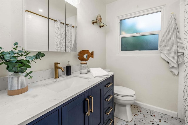 bathroom featuring toilet and vanity