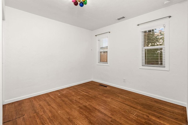 empty room featuring hardwood / wood-style flooring and a wealth of natural light