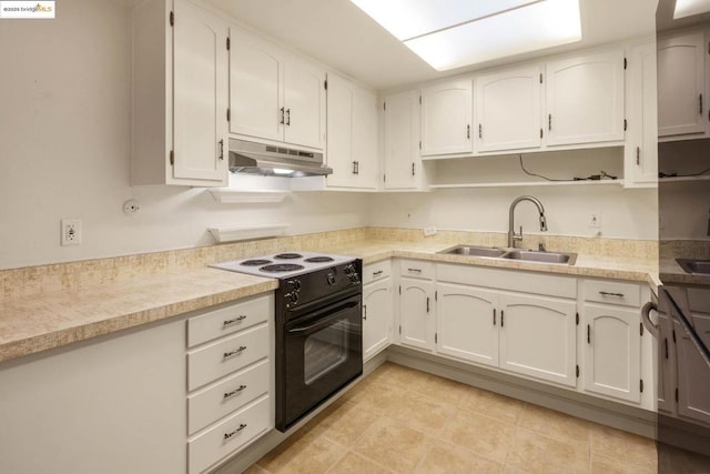 kitchen with white cabinetry, sink, and black / electric stove