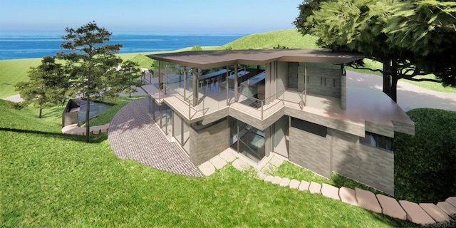 back of property with a balcony, a water view, and a lawn