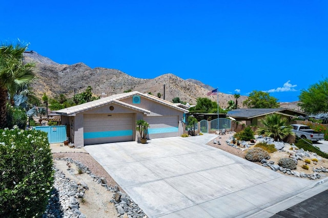 view of front of property featuring a mountain view and a garage