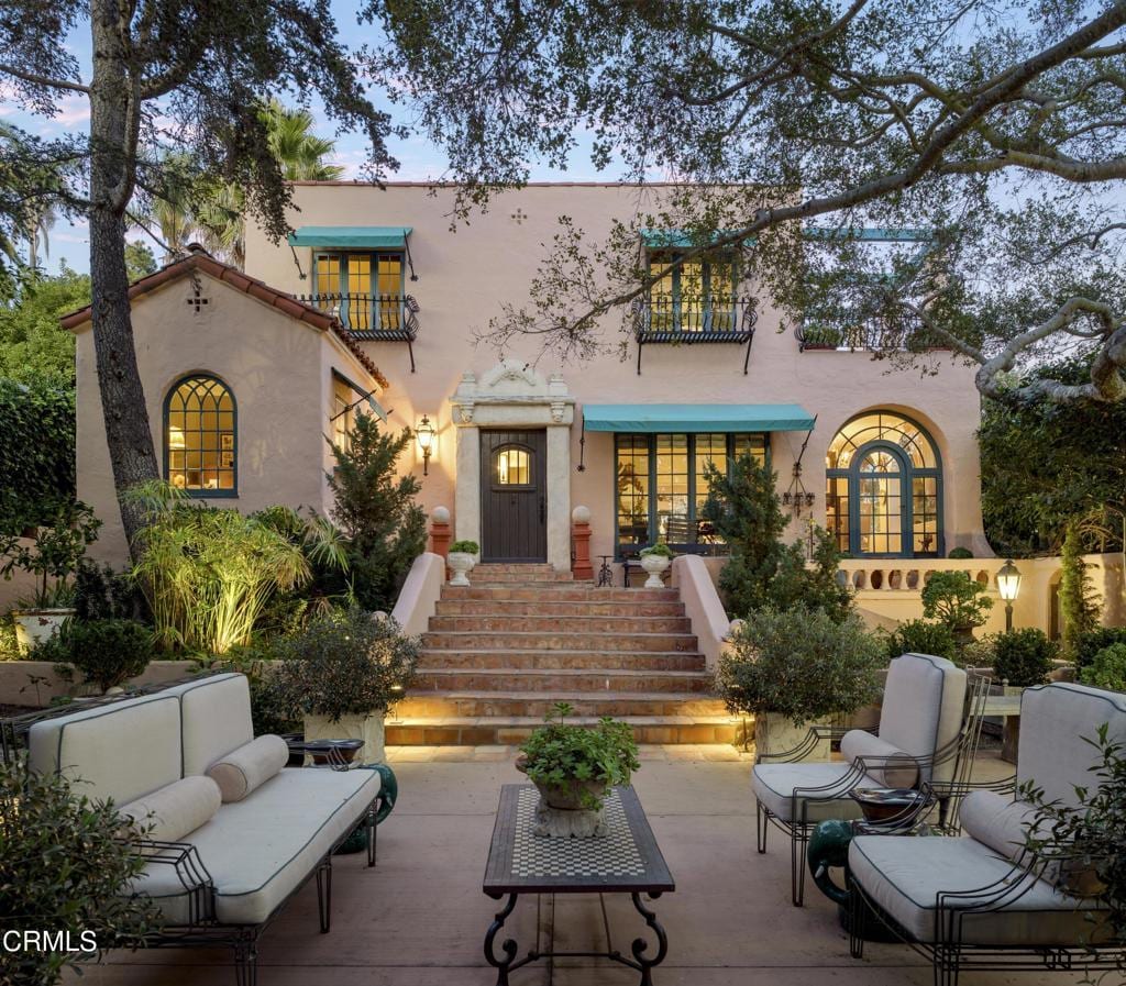 back house at dusk featuring an outdoor living space