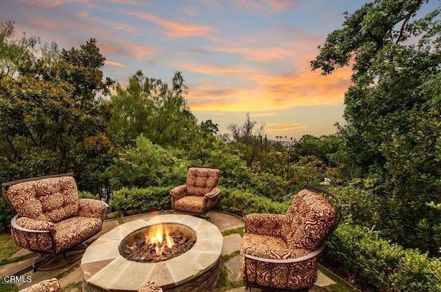 patio terrace at dusk with an outdoor fire pit