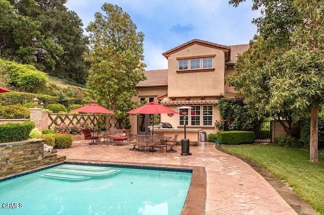 rear view of house featuring a patio area and a bar