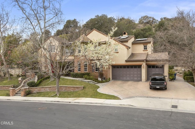 view of front of property with a garage and solar panels